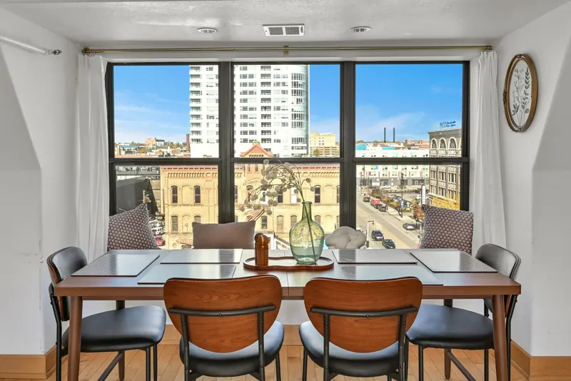 The penthouse dining table by the window with Old World Third Street below