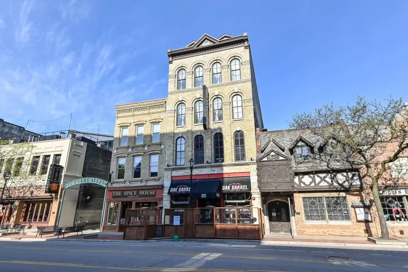 Old World Third Street in downtown Milwaukee: Oak Barrel Public House at street level in a row of Victorian brick buildings