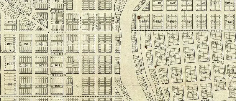 Detail of an 1856 map of Milwaukee: the west-bank street grid meets a differently angled grid on the east bank