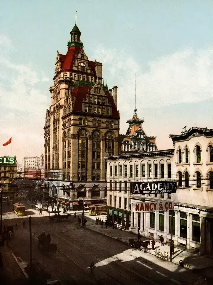 A colorized 1900 view of Wisconsin Street with the tall Pabst Building, a streetcar and horse-drawn wagons