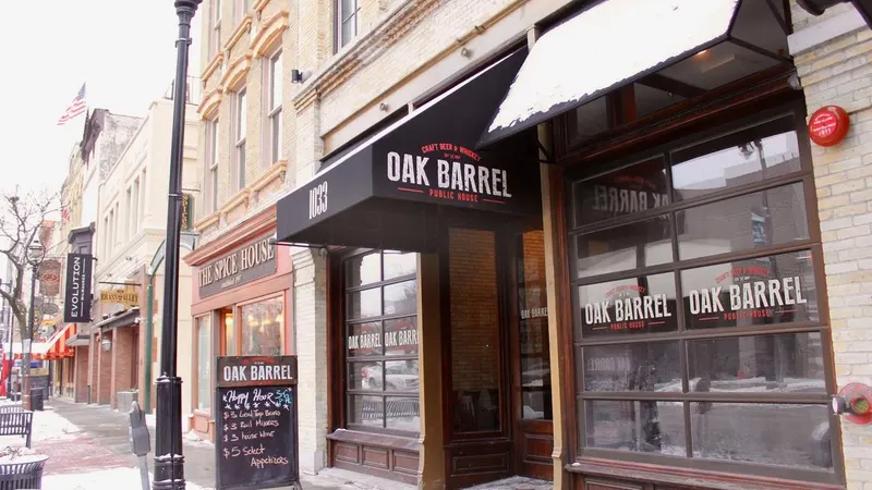 The Oak Barrel Public House storefront with its black awning and chalkboard sign on Old World Third Street