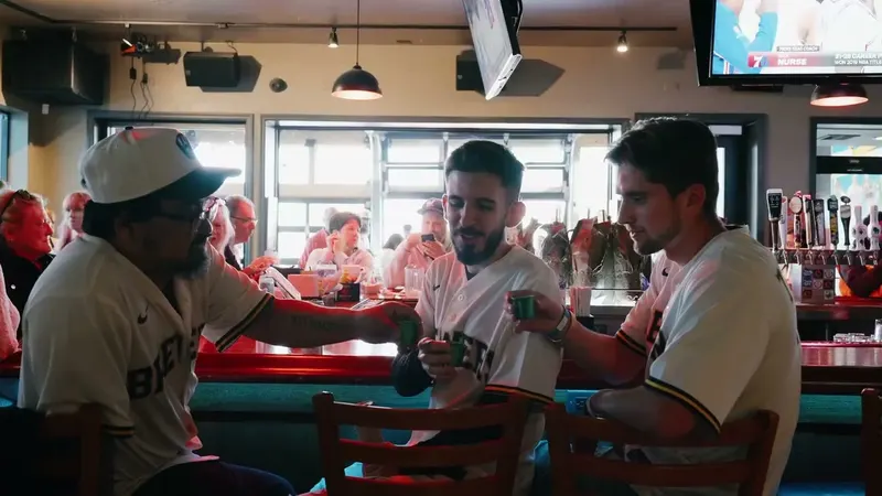 Three fans in Brewers jerseys at a table at Who's on Layton